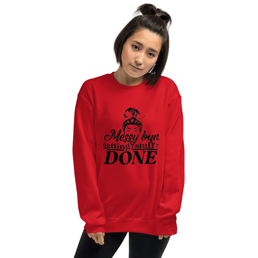 a woman wearing a red sweatshirt with the words merry bun sitting on top of it