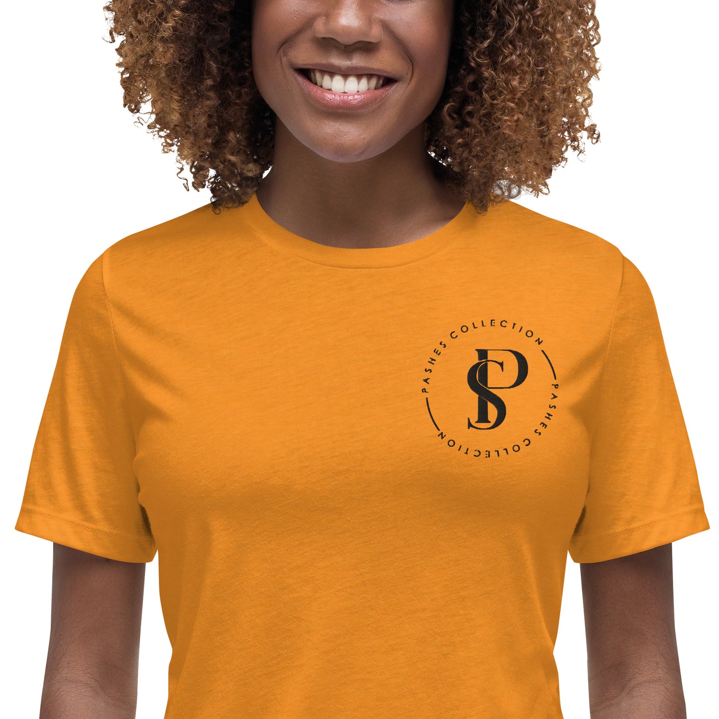 a woman wearing an orange shirt with a logo on it